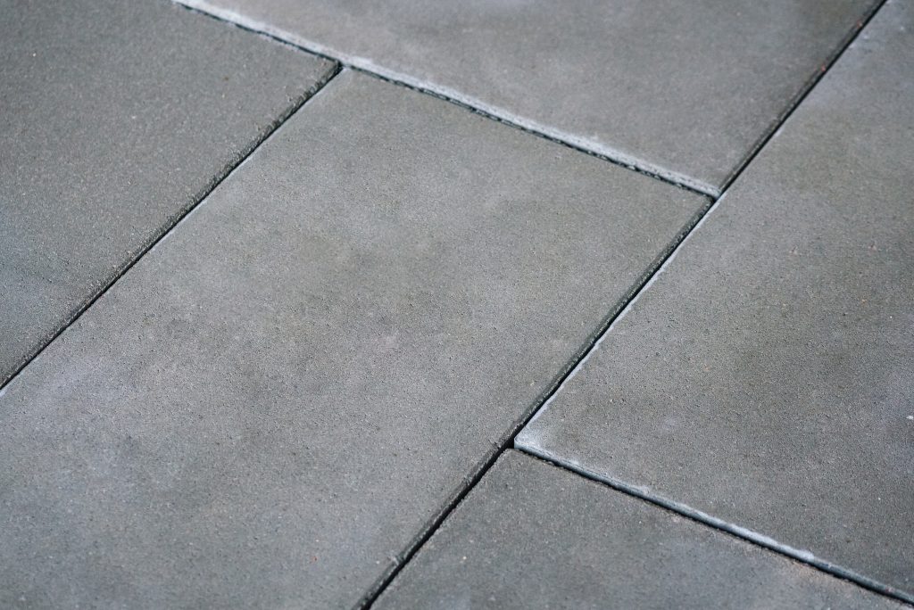 Close-up view of smooth concrete paving slabs, highlighting their clean finish and durability.