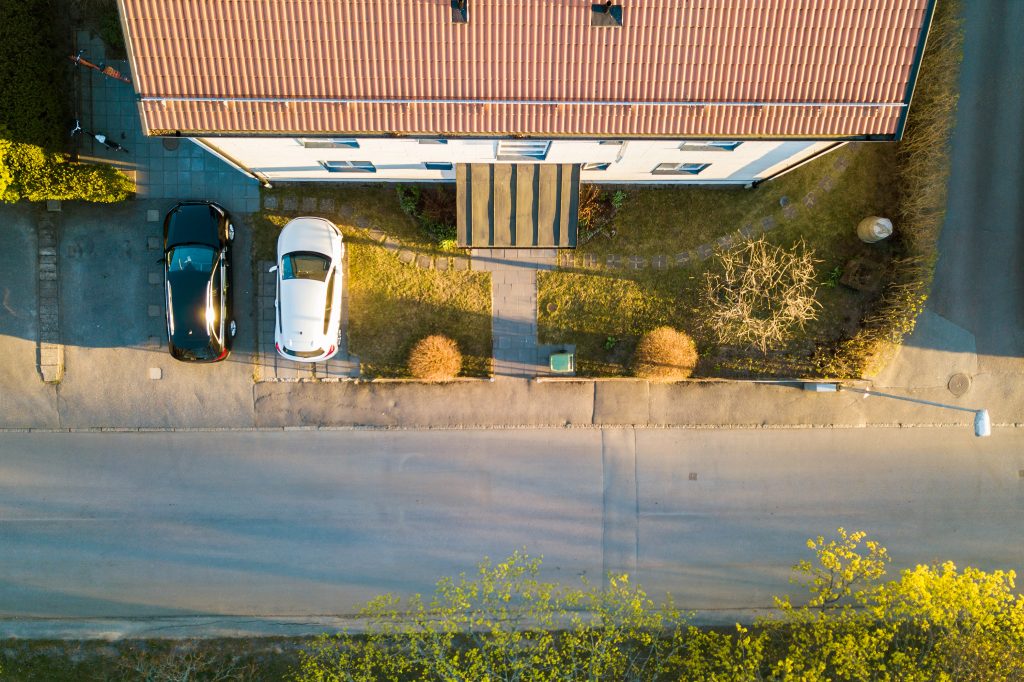 Aerial view of a residential property with a concrete driveway