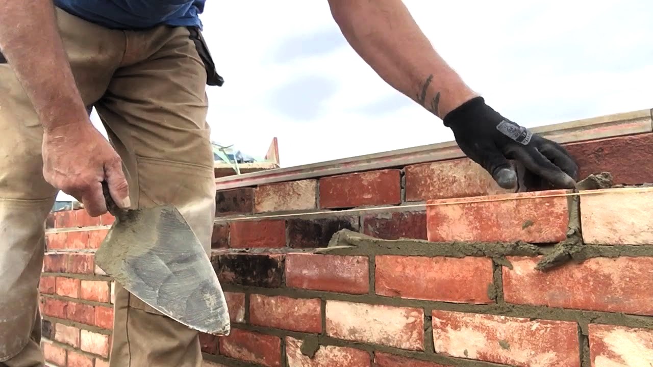 Worker assembling bricks