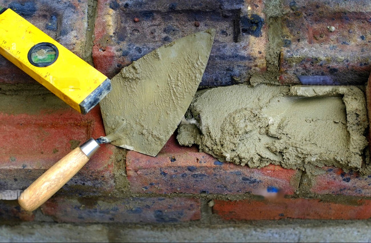 Bricklaying tools and mortar on a building site